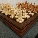 Chess set with a brown ash board decorated with leaf carvings and chess pieces "Game of Thrones"
