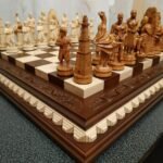 Chess set: ash chess board in brown with leaf carving on the top and chess pieces "Game of Thrones"