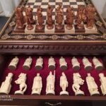 chess set: ash board with decorative carving and two storage boxes; Knights & Cossacks pieces