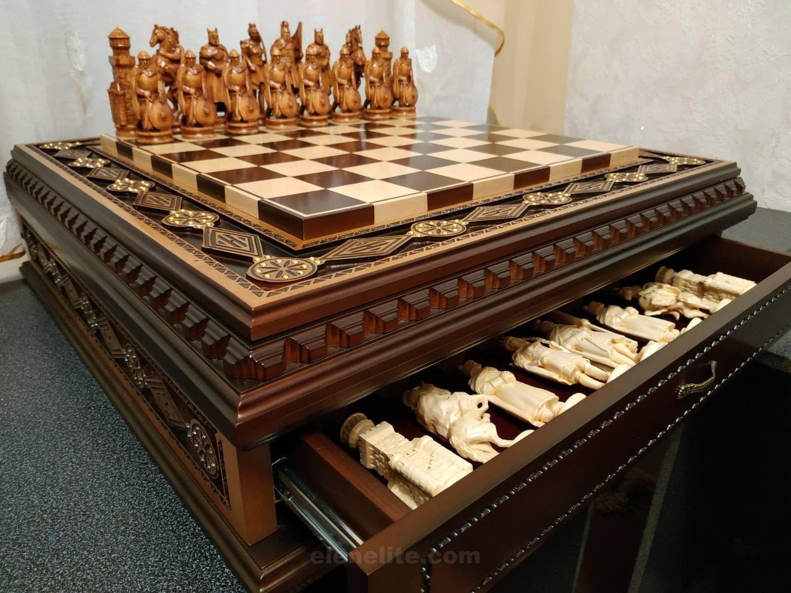 il_fullxfull.2442209805_h7e6.jpg Handcrafted chess set. The board is made of ash in a dark brown color with carvings and 2 drawers for storage