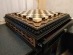 the chess board is equipped with 2 drawers for storing chess pieces and is inlaid with a beads