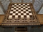 An elegant ash chess board with contrasting carvings and bead inlay - handcrafted with a distinctive wood grain