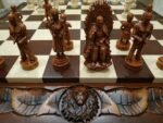 Vintage wooden chess board with handmade chess pieces