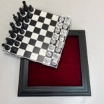 A black and white chessboard with a removable board. Inside is a convenient compartment for storing pieces. The set includes a classic set of chess pieces.