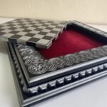 An elegant wooden chess board with a removable game board and velvet storage for the pieces