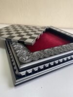 An elegant wooden chess board with a removable game board and velvet storage for the pieces