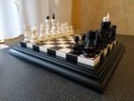 Chess set: Traditional wooden chess board with carved chess figures
