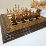 An elegant handmade chess set. The ash board with an ombre effect and glossy finish