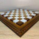 Ash chess board with a spectacular ombre colour from dark to light brown, decorated with carvings and covered with a super-gloss varnish