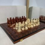 Unique folding ash board with a compartment for storing each chess piece.