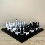 A classic handmade chess set featuring a black and white natural ash