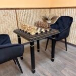 Handcrafted chess set with Spartan warriors on wooden chess table